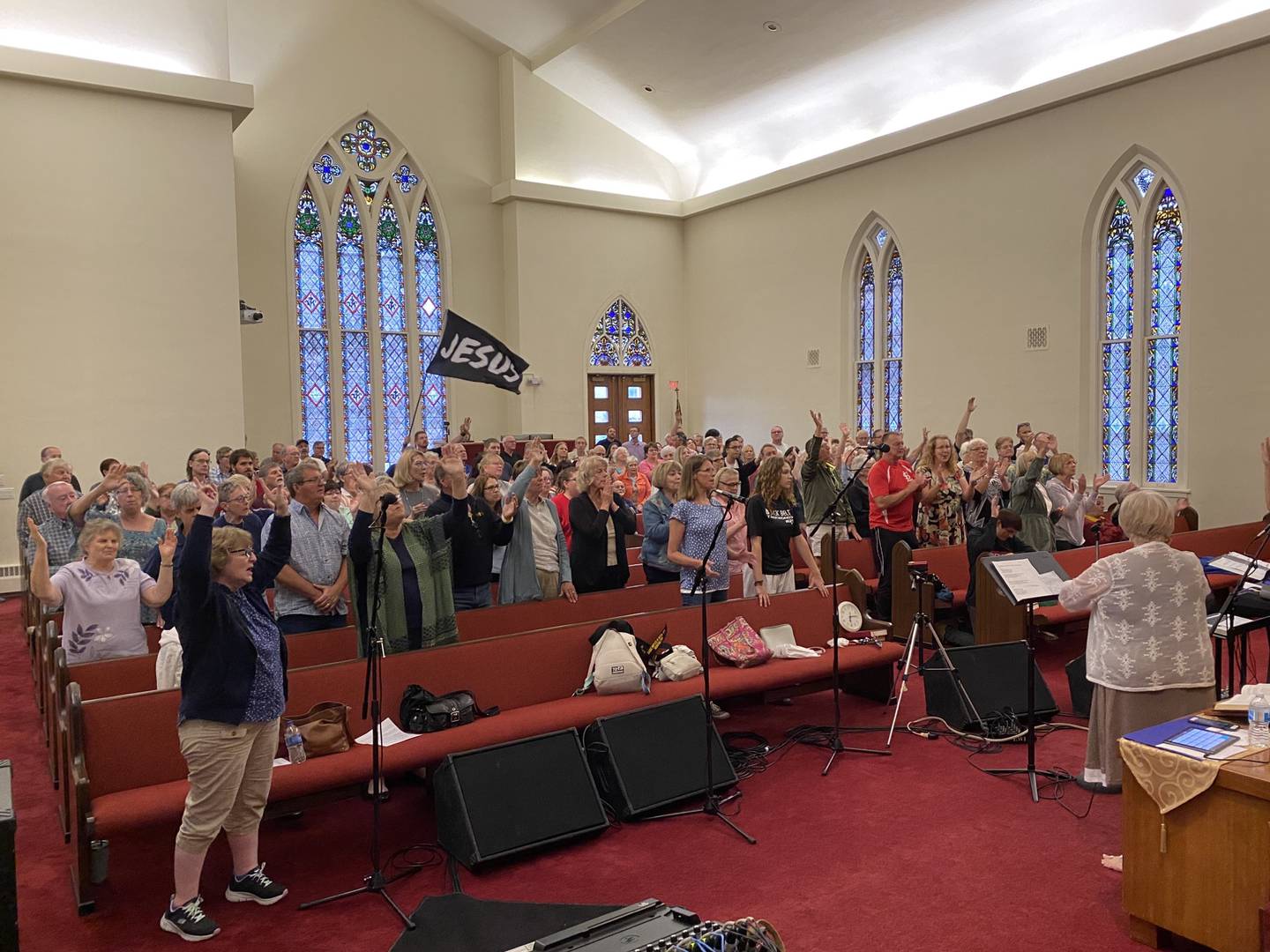The congregation at Ottawa's Praise in the Park moved indoors following some rain to First Presbyterian Church to sing “Our God is an Awesome God” together with Brent and Michelle Mitchell.
