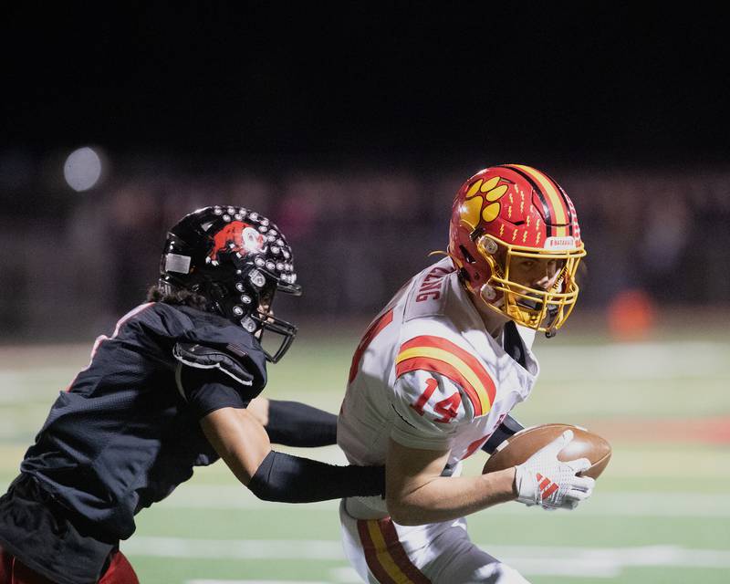 Glenbard East's Mike Orive looks for the tackle on Batavia's Brennon Zeng at the Class 7 A Second Round playoff game on Friday, Nov. 7,2025 in Lombard.