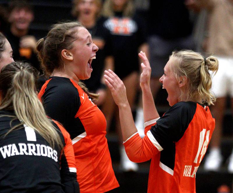 McHenry’s Riley Ten Bruin, left, and Maddy Weber celebrate a point against Crystal Lake South in varsity volleyball at McHenry Tuesday night.
