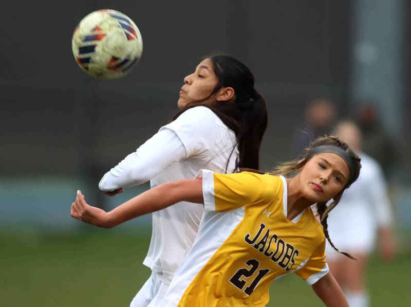 Jacobs’ Kylie Deegan, right, battles Hampshire’s Fabiola Martinez in varsity girls soccer on Thursday, April 17, 2025, at Jacobs High School in Algonquin.
