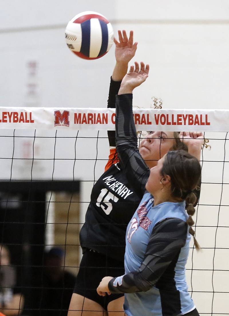McHenry's Sophie Zieba hits a ball as Marian Central's Alex Rewiako tries to get to it during a nonconference volleyball match Monday, Aug. 28, 2023, at Marian Central Catholic High School.