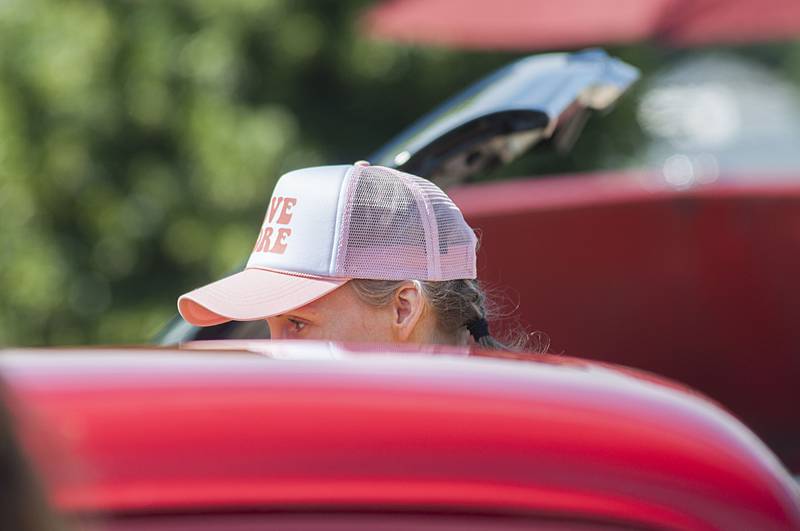 Rebecca Shaver of Michigan checks out the rides during the Petunia Fest car show. Shaver is camping in Rock Falls with her family so made the trip in to check out all the Petunia fun.