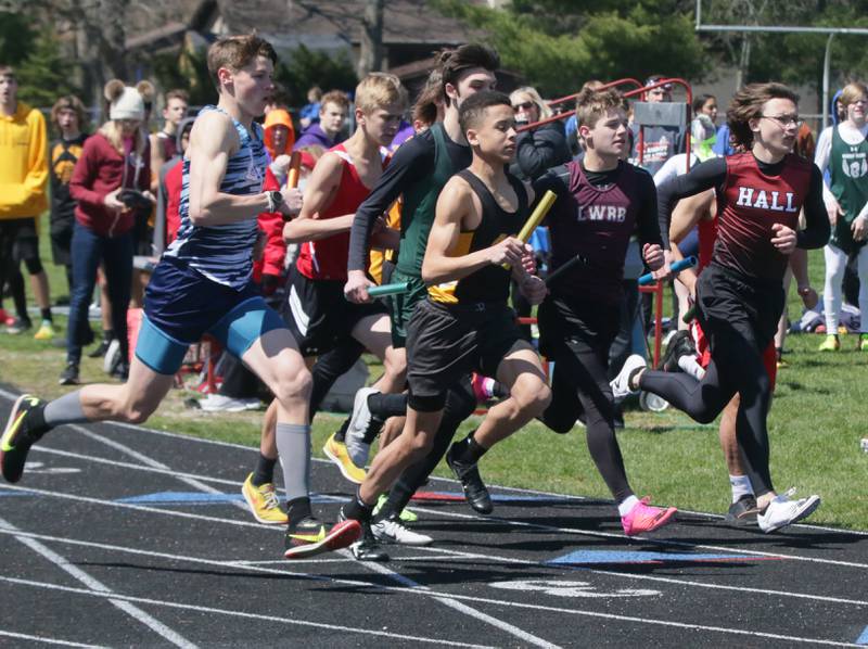 Boys run in the 4x800 meter relay during the Rollie Morris Invite on Saturday, April 16, 2022 at Hall High School in Spring Valley.