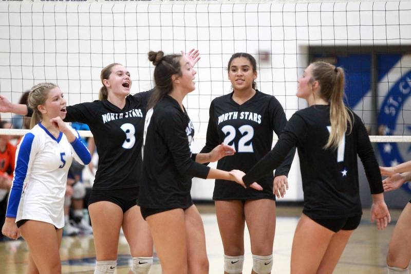 St. Charles North players celebrate one of their final points in a win over Oswego Wednesday, Sept. 18, 2024 at St. Charles North.