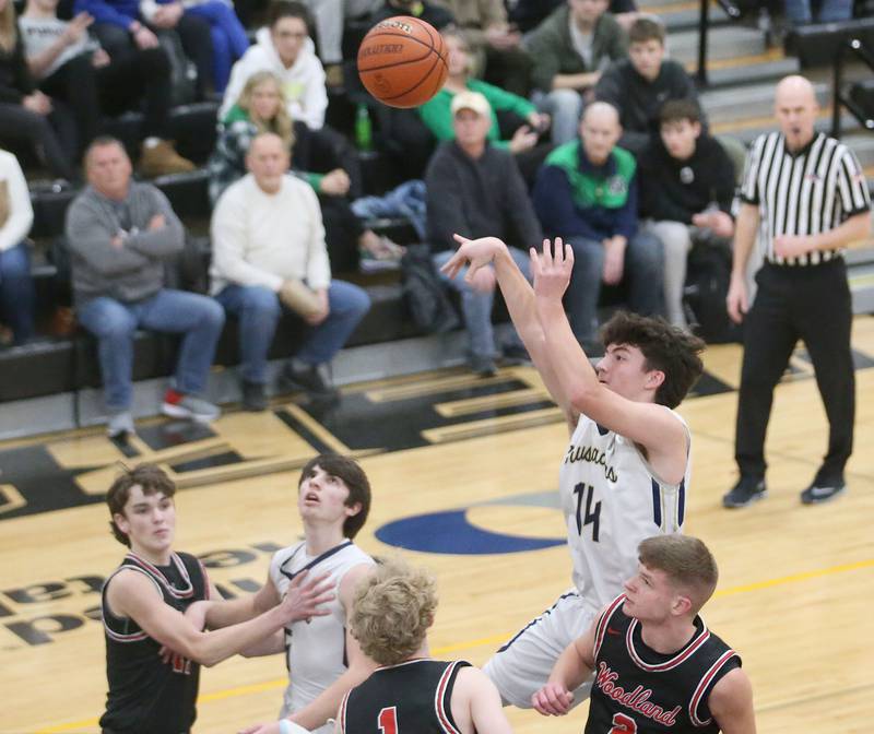 Marquette's Carson Zellers shoots a shot over Woodland's Connor Dodge during the Tri-County Conference Tournament on Thursday, Jan. 25, 2024 at Putnam County High School.