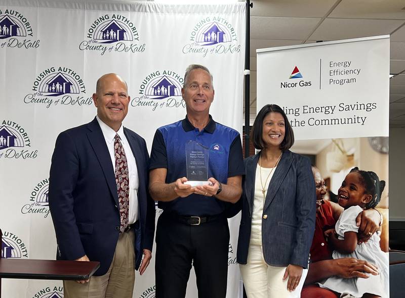 ComEd's Louie Binswanger and Meena Beyers, vice president of business & community development for Nicor Gas on Sept. 5, 2024 presented a trinket to Randy Bourdages, declaring the Housing Authority of DeKalb County a premier partner of their companies' multi-family energy savings program.