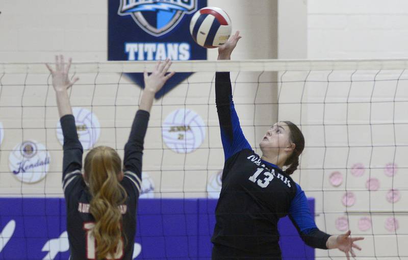 Newark’s Rylie Carlson tries to get this volley past Aurora Christian’s Breanna Hard in the 1st set Thursday at the Serena Regional .