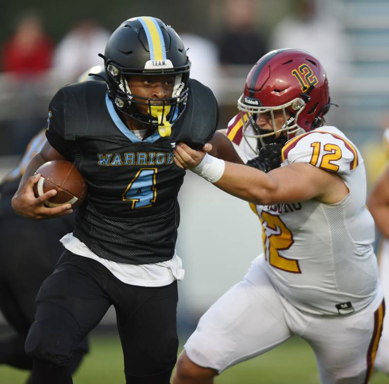 Joe Lewnard/jlewnard@dailyherald.com
Maine West’s Onell Miller-Smith moves past Schaumburg’s Jimmy Frejd on a carry during Friday’s game in Des Plaines.