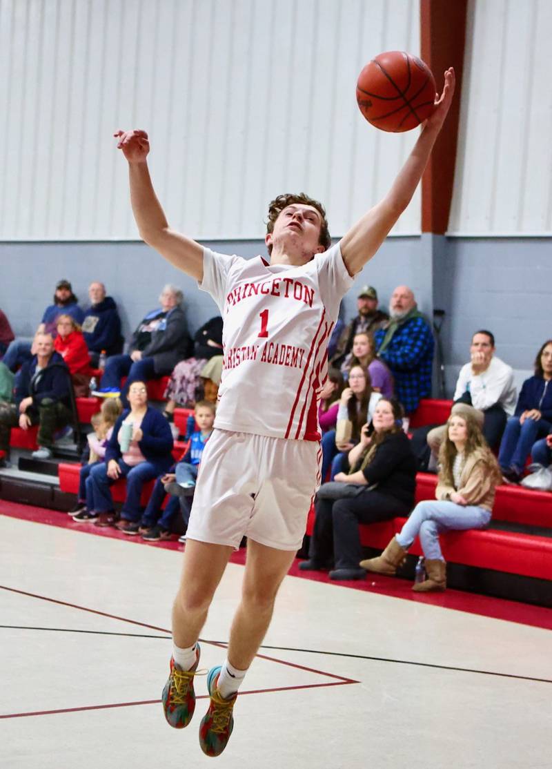Princeton Christian Academy's Julian Mucha grabs a rebound in Tuesday game with Ottawa Christian Academy at Howard Hoffman Memorial Gym. The Eagles won 57-42.