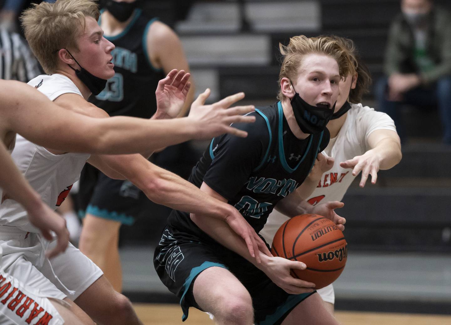 Woodstock North's Rex White (center) is defended by McHenry's Jack Waters (left) and Dillon Maciaszek (right) during the Woodstock North vs. McHenry boys basketball game on Saturday, December 4, 2021 at McHenry High School. McHenry won in overtime 58-52. Ryan Rayburn for Shaw Local