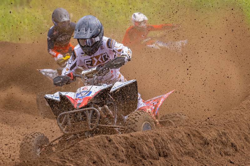 ATVMX pro rider Jeffrey Rastrelli battles off two oncoming racers while riding through debris during the ATVMX Championship race on May 24, 2025 at Sunset Ridge MX in Walnut.