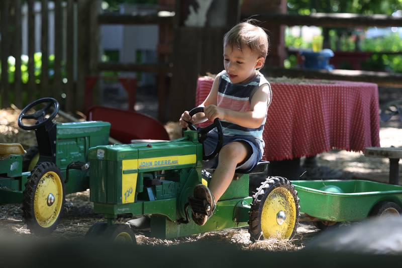 Grayson Caffle, 3-years old of Manhattan rides a tractor at the Children’s Garden in Elwood. The Children’s Garden in Elwood recently celebrated their 25th anniversary. Saturday, July 9, 2022 in Elwood.