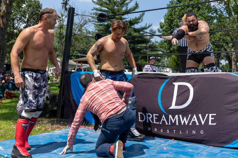 Wrestlers gather around outside of ring at the Taste of the Illinois Valley DreamWave Wrestling event on Saturday, August 2, 2025 at Centennial Park in Peru.