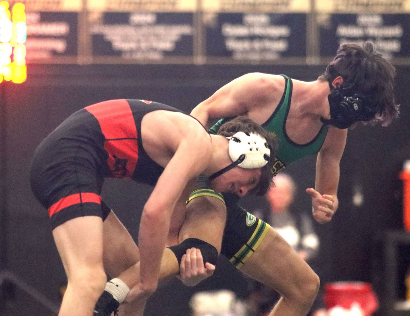 Batavia’s Kai Enos, left, battles Geneseo’s  Esref Onder at 120 pounds in varsity boys wrestling on Thursday, Feb. 5, 2026, at Sycamore High School in Sycamore.