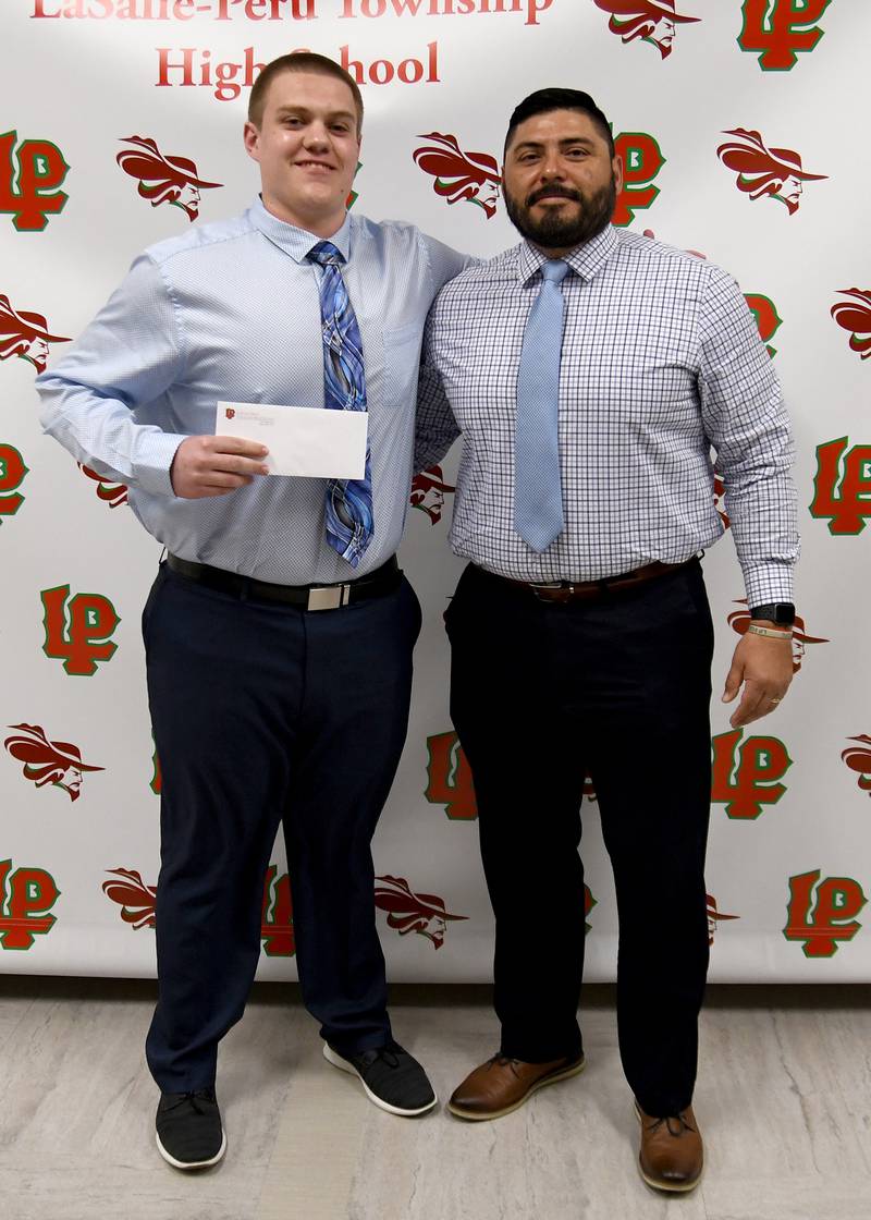 Nikolas Belski (left), a LaSalle-Peru High School senior, received the $1,000 William Plantan Football Scholarship. The scholarship is awarded to a L-P football player who exhibits a high standard of leadership and citizenship and who plans to attend a two-year or four-year college. Belski also received the Mike Kasap Memorial Football Scholarship. The $1,000 scholarship recipient is chosen by the Kasap family for his devotion and loyalty to the sport of football. The awards were presented by L-P football coach Jose Medina.