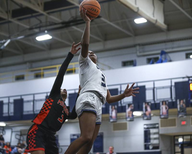 Oswego East's Avaya Kittling-Turner (3) goes in for a layup during their basketball game between Minooka at Oswego East Friday, Jan 16, 2026 in Oswego.