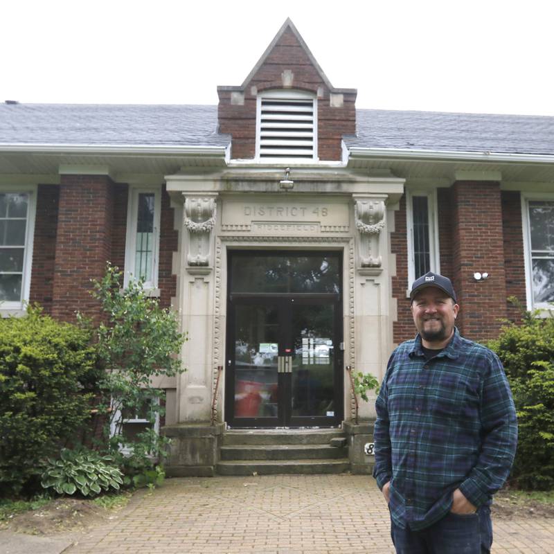 Brent Hollenberg in front of the former Ridgefield schoolhouse at 8617 Ridgefield Road, near Crystal Lake on Wednesday, May 21, 2025. Hollenberg plans to turn the schoolhouse into a six-unit Airbnb. The building was last the home of the McHenry County Jewish Congregation.