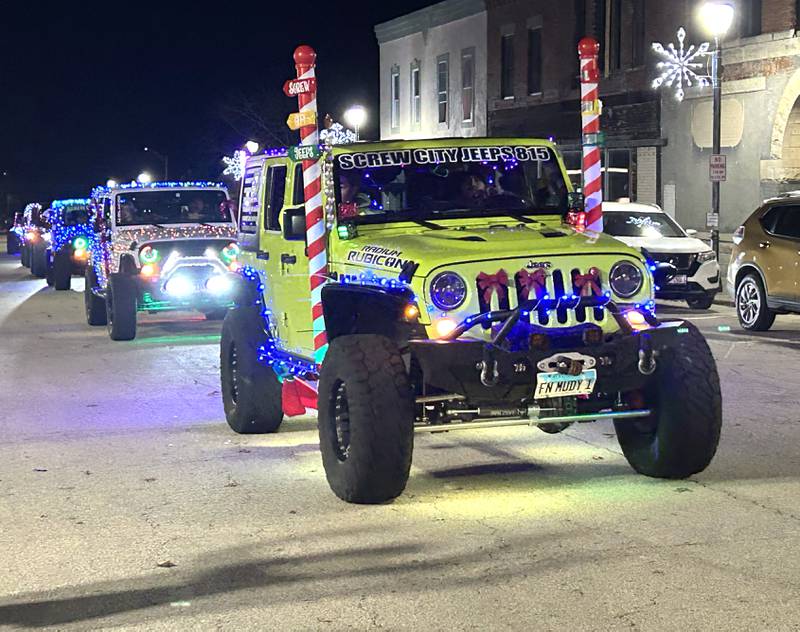 Decorated Jeeps head down Wesley Ave. in the lighted parade during Mt. Morris' Christmas in the Village on Saturday, Dec. 7, 2024.