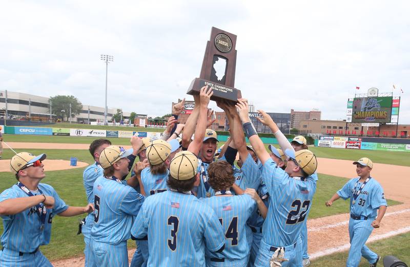 Members of the Marquette baseball team hoist the Class 1A championship trophy after defeating Altamont 6-2 to win the Class 1A championship on Saturday, June 1, 2024 at Dozer Park in Peoria.