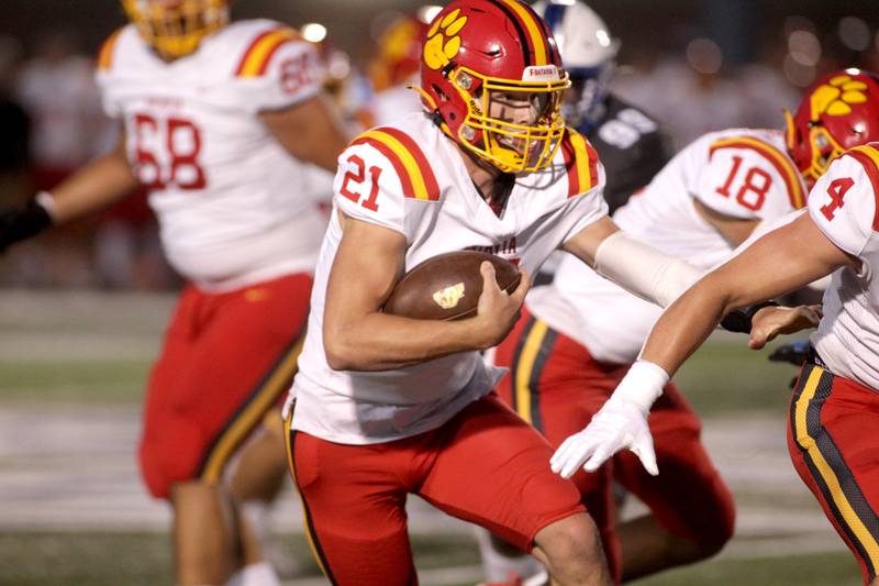 Batavia quarterback Ryan Boe keeps the ball during a game at St. Charles North on Friday, Sept. 15, 2023.
