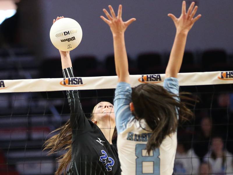 St. Francis's Addy Horner (22) sends a kill past Joliet Catholic's Olivia Chovanec (8) in the Class 3A semifinal game on Friday, Nov. 11, 2022 at Redbird Arena in Normal.
