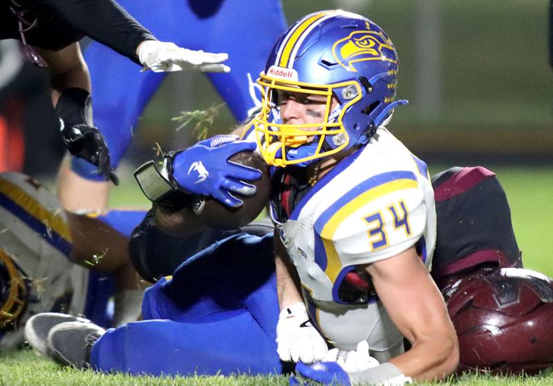 Johnsburg’s Duke Mays lands with the ball in varsity football at Rod Poppe Field on the campus of Marengo High School in Marengo on Friday, Oct. 3, 2025.