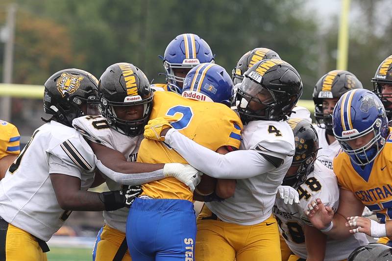 Joliet West’s Mohamed Kosh, 40, and Micah McNair, 4, wrap up Joliet Central’s Christian Smith on Saturday, Sept. 28, 2024 in Joliet.