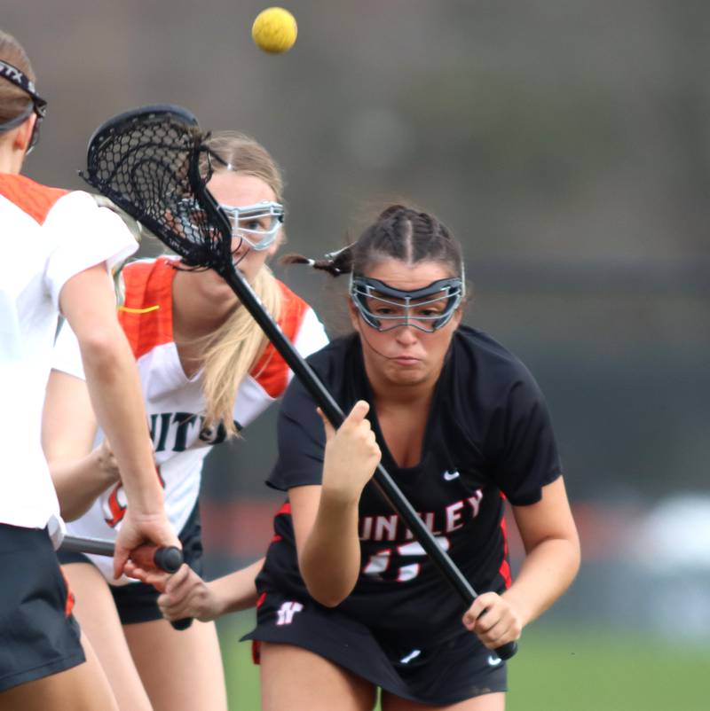 Crystal Lake co-op’s Alivia Nielsen, back battles Huntley’s  Briana Winger, right, for the ball in varsity girls lacrosse on Friday, April 18, 2025, at Metcalf Field on the campus of Crystal Lake Central High School in Crystal Lake.
