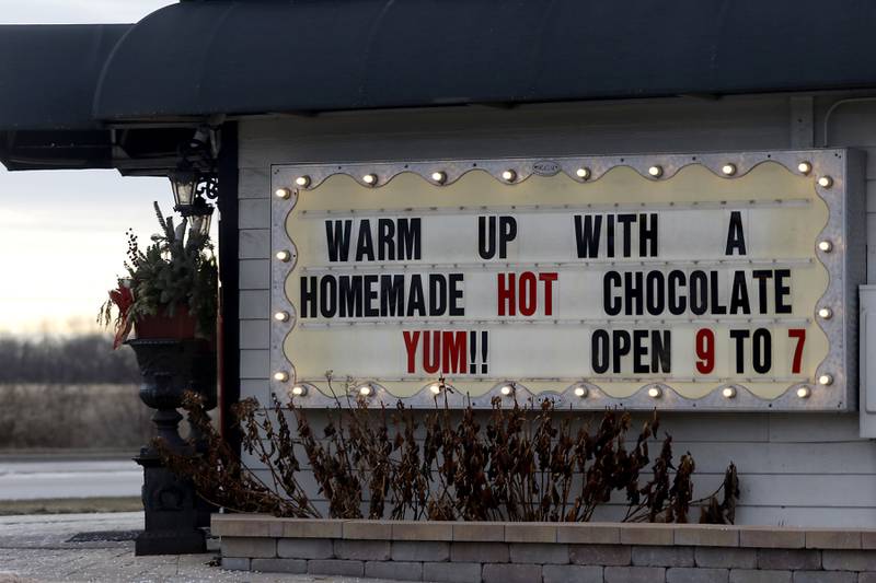 On a cold Wednesday, Jan, 8, 2025, the Riverside Chocolate Factory in McHenry advertises hot chocolate as a way to warm up.