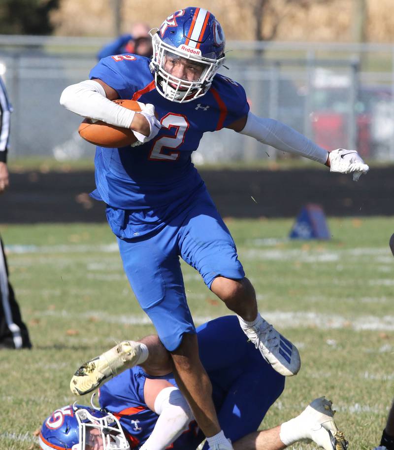 Genoa-Kingston's Traven Atterberry jumps over a teammate as he carries the ball during their first round playoff game against Elmwood Saturday, Oct. 29, 2022, at Genoa-Kingston High School.