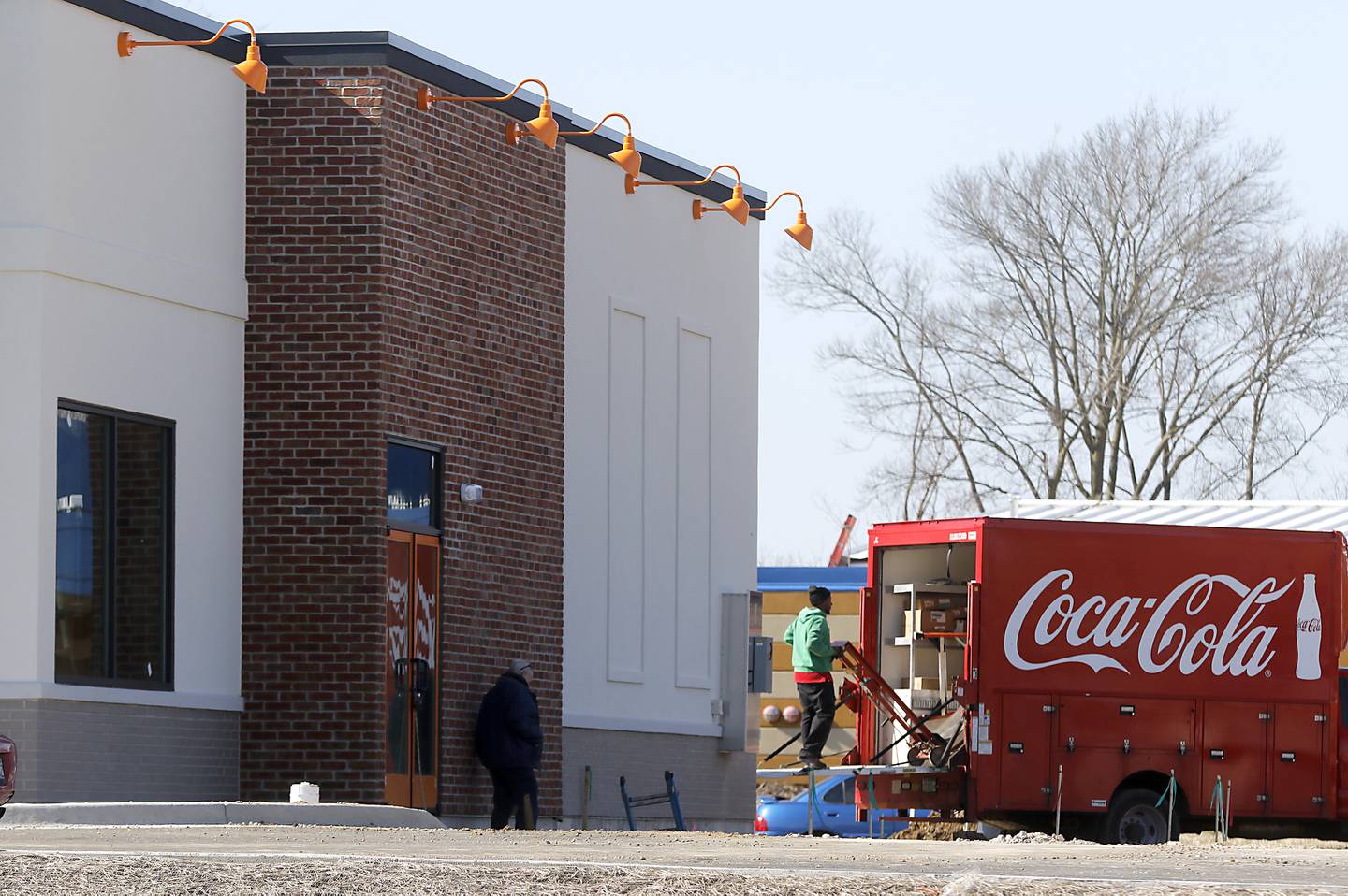 A worker from Coca-Cola works on the new Popeyes Louisiana Kitchen restaurant at 2075 East Algonquin Road, in Algonquin, on Friday, April 7, 2023.