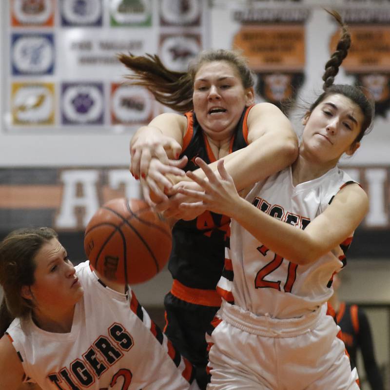 McHenry's Lynette Alsot, center, tries to rebound the ball over Crystal Lake Central's Scarlett Quinn, left, and Quin O'Donnell, right, during a Fox Valley Conference girls basketball game Tuesday, Nov.. 29, 2022, between Crystal Lake Central and McHenry at Crystal Lake Central High School.