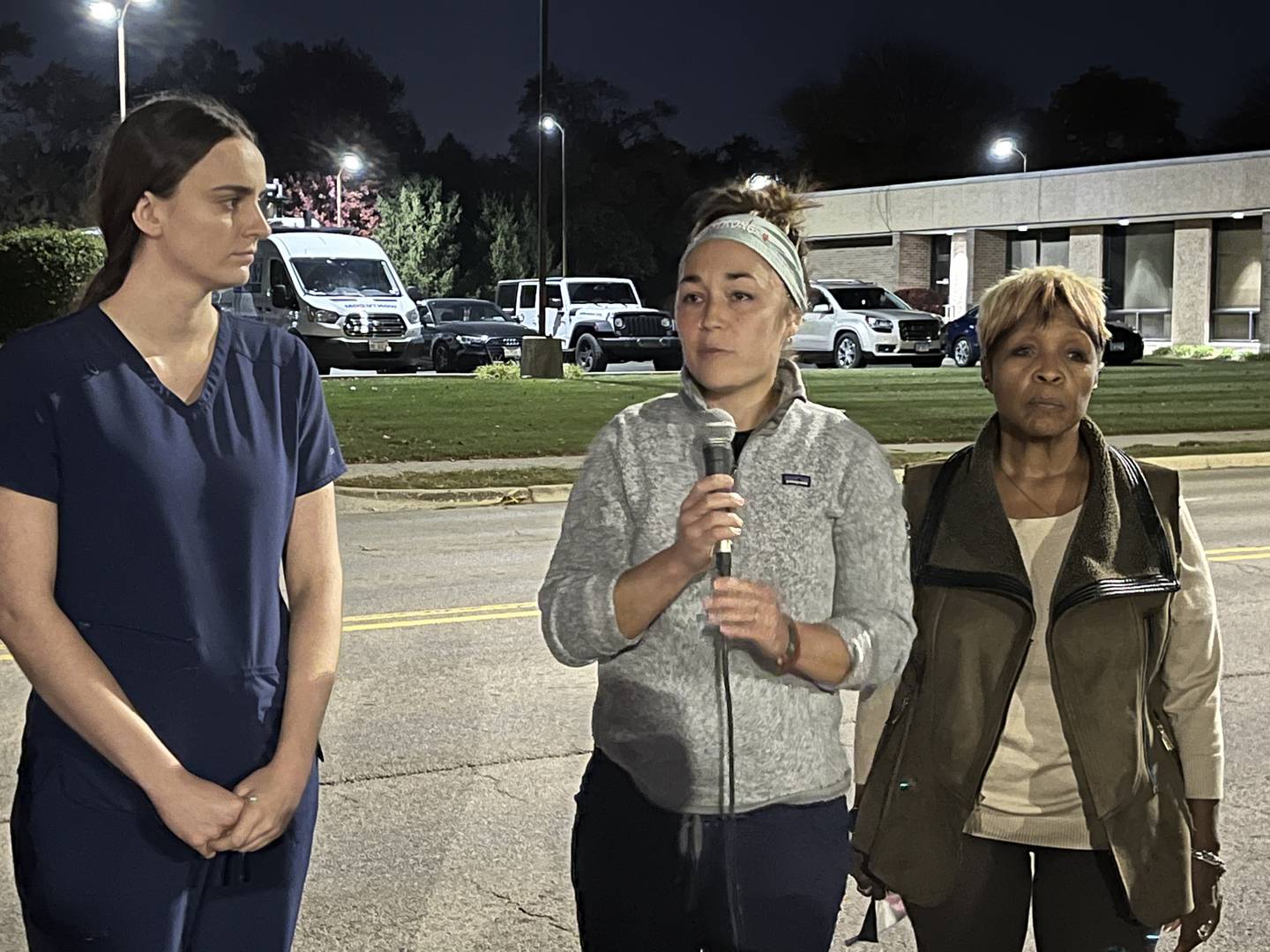 Hannah Puhr (center), an emergency room nurse at Ascension Saint Joseph Medical Center in Joliet, holds a microphone while speaking at a rally on Saturday Oct. 22, 2022. Standing next to Puhr is Katherine Soprych, an Intensive Care Unit nurse (left), and Pat Meade (right), treasurer for the St. Joseph Nurses Association.