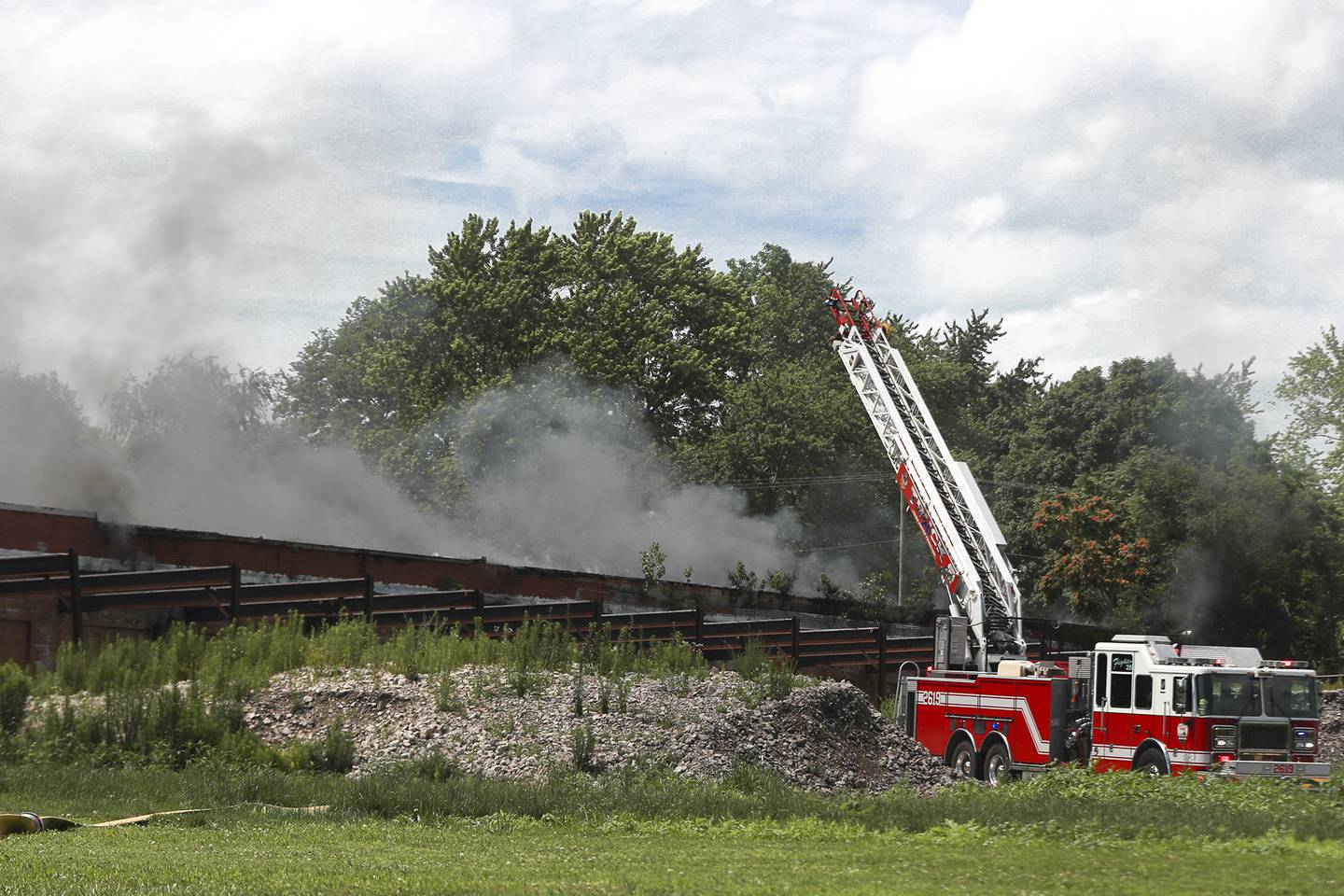 A ladder truck pulls up closer to the blaze on Tuesday, June 29, 2021, at the 900 block of East Benton Street in Morris. More than 40 homes in the area were evacuated after an industrial building caught fire late that morning.