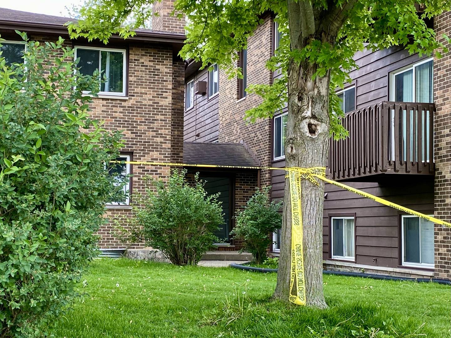 Crime scene police tape ropes off a portion of the parking lot off on Wednesday, May 28, 2025, at Russell Road Apartments, 822 Russell Road, DeKalb. One person suffered serious injuries in a mid-afternoon shooting outside the building, DeKalb Police Chief David Byrd said.