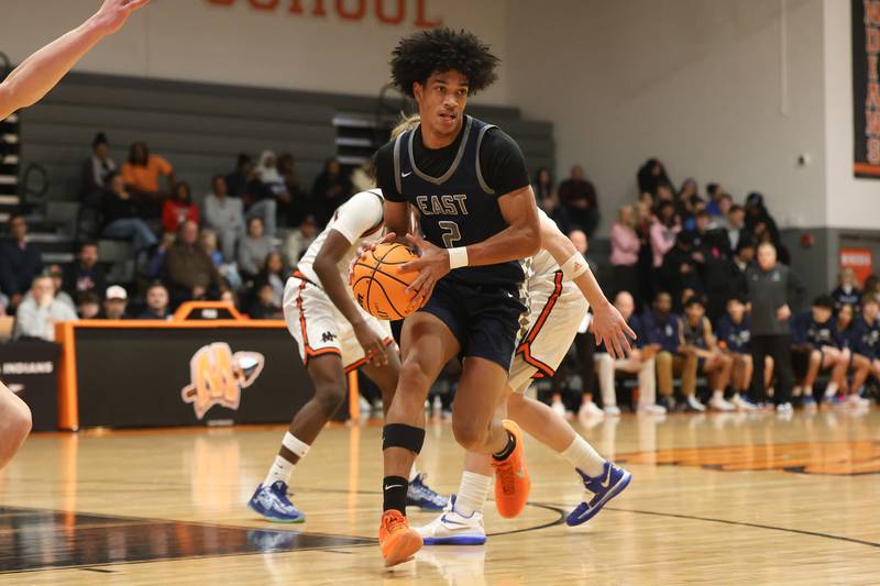 Oswego East’s Jacsen Tucker looks to pass against Minooka on Friday, Jan. 16, 2026 in Minooka.