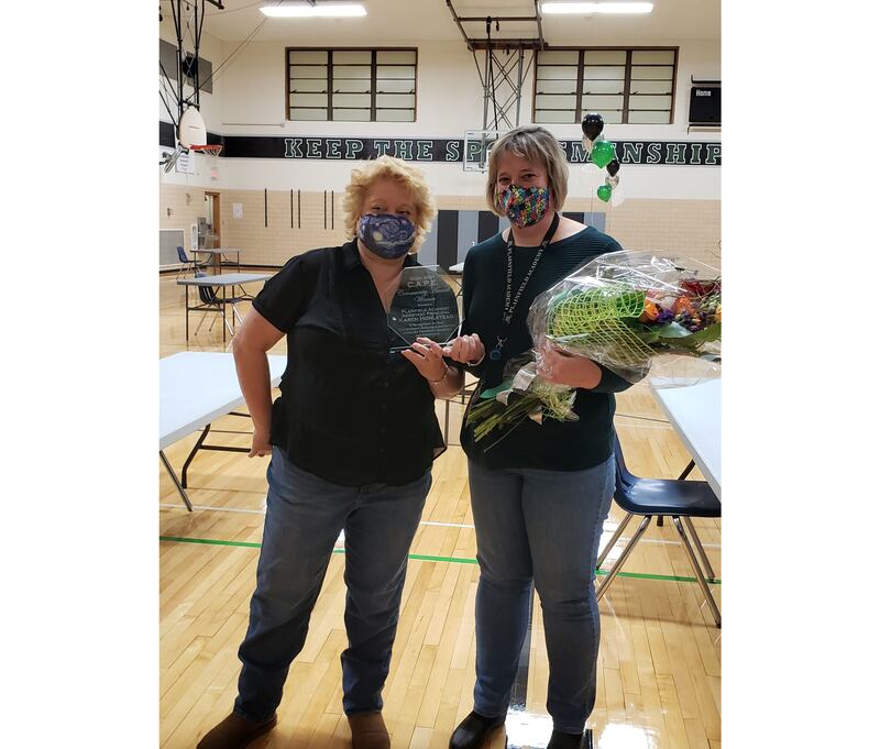 Betsey Vinson (left), president of the District 202 C.A.P.E. parent organization, presents the 2021 C.A.P.E. Community Award to Plainfield Academy Assistant Principal Karyn Holstead. The award recognized Holstead’s extraordinary multi-faceted work at the school, especially during the transition between principals two years ago, and her community volunteerism.