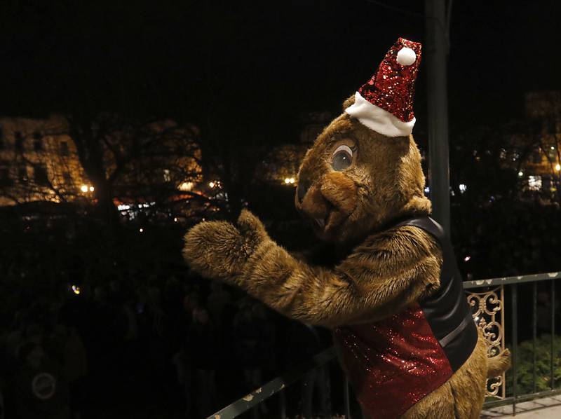 Woodstock Willie works the crowd during the Lighting of the Square Friday, Nov. 25, 2022, in Woodstock. The annual event featured brass music, caroling, free doughnuts and cider, food trucks, festive selfie stations and shopping.