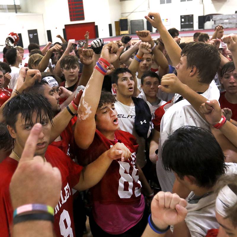 Huntley’s Kaden Buchholz, wearing jersey number 89, leads the team out of practice during the first day of football practice Monday, 8, 2022, in the Huntley High School  field house after stormy weather move practice inside.