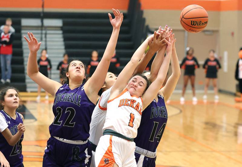 DeKalb's Ella Russell fights for a rebound between two Rochelle players during their game Monday, Nov. 28, 2022, at DeKalb High School.