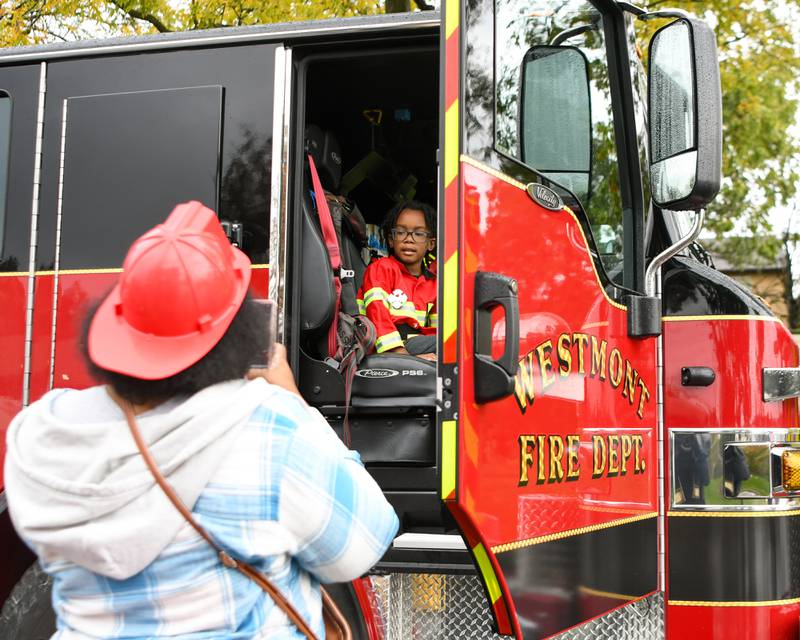Camden Betler, 6 years old, gets his photo taken by his mom Ashley Betler of Westmont during the Westmont fire department 100 year anniversary celebration held on Saturday Oct. 14, 2023.