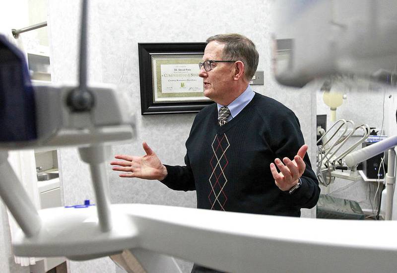 Dr. David Potts stands in front of a Cone Beam CT Machine as he talks about how it is used for diagnosis and treatment planning for his patients at Lake County Dental Care in Libertyville.