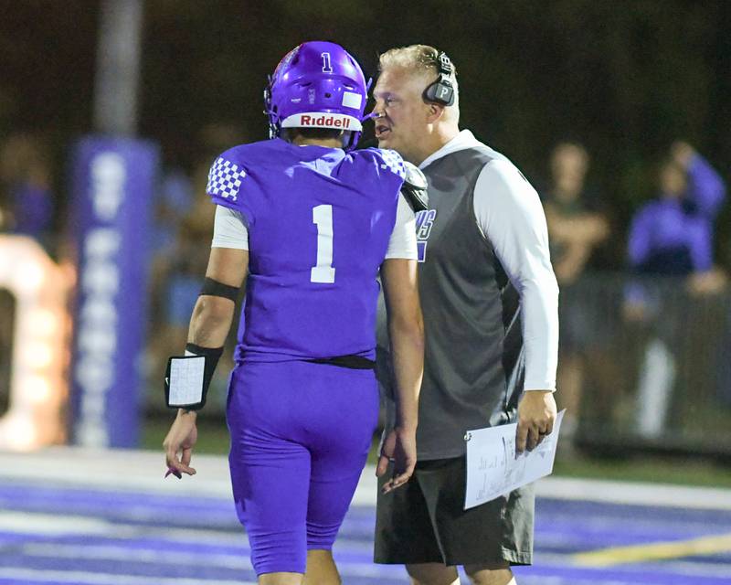 St. Francis offensive coordinator coach Lonny Stare talks with Brock Phillip (1) during a break in the action while taking on IC Catholic Prep on Friday Oct. 3, 2025, held at St. Francis High School.