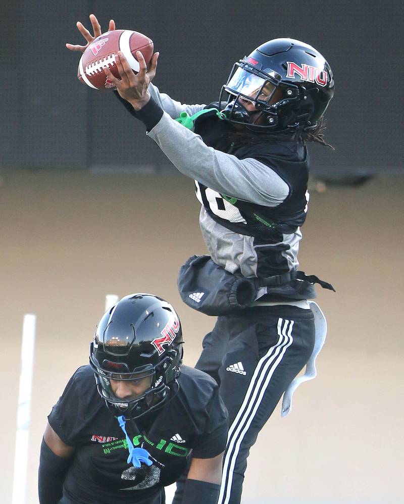 Northern Illinois University cornerback  	Amariyun Knighten makes a catch over cornerback Javaughn Byrd during a drill at spring practice Friday, April 7, 2023, in Huskie Stadium at NIU in DeKalb.