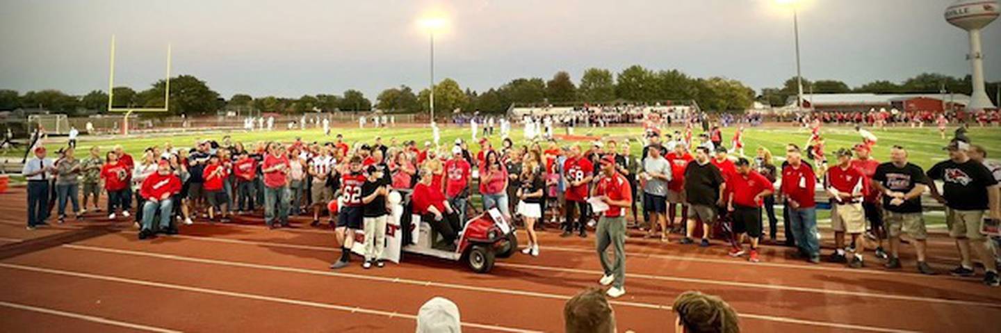 Family, former students and community members gather to honor former Yorkville High School football coach Robert Evans at the homecoming game on Oct. 03, 2025.