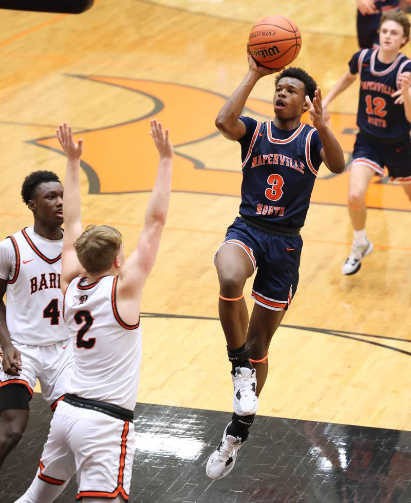 Naperville North's Bryce Welch shoots in front of DeKalb’s Sean Reynolds during their game Friday, Dec. 8, 2023, at DeKalb High School.