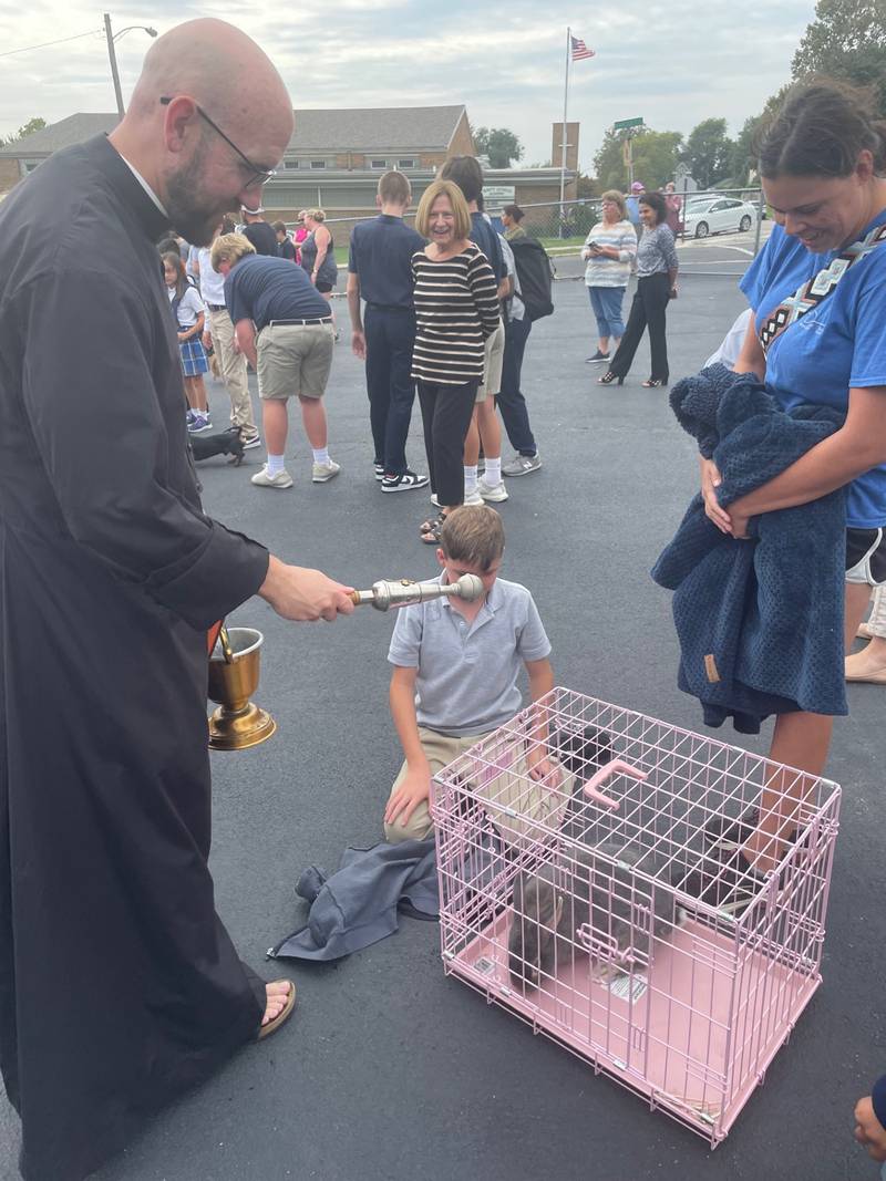 Yes, bunnies are eligible for the blessing, too. Ben Gedraitis and mom Nicole of La Salle stand over a pet crate while the Very Rev. Thomas Otto, pastor of the La Salle Catholic Parishes, blesses pat rabbit Fluffy during the yearly blessing of the animals held Wednesday, Oct. 4, 2023, outside St. Patrick Catholic Church, La Salle. The blessing is conducted on the feast of St. Francis of Assisi, whose love of animals extended to bunnies.