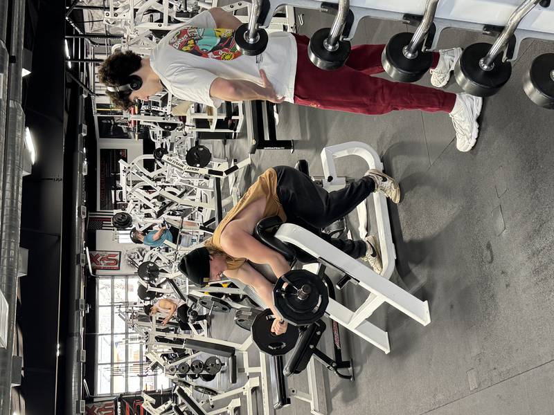 Nate Lough gets ready for a curl at X-ercise Science Personal Training and Fitness, located at 830 Harrison St. in Peru, while his workout partner, Tom Makransky, watches. Both of them said they enjoy going to X-ercise Science to take the necessary steps to stay in shape and get stronger.