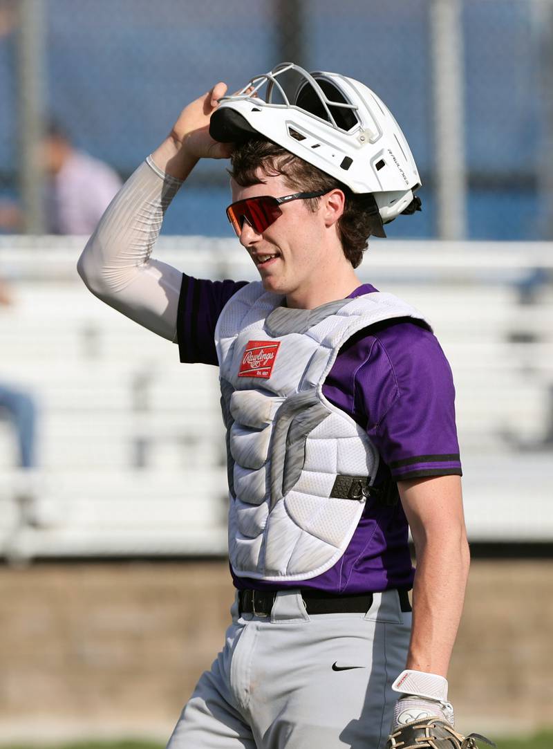 Downers Grove North's catcher Jimmy Janicki walks off the field after the 1st inning during the boys varsity baseball game between Lyons Township and Downers Grove North high schools in Western Springs on Tuesday, April 11, 2023.