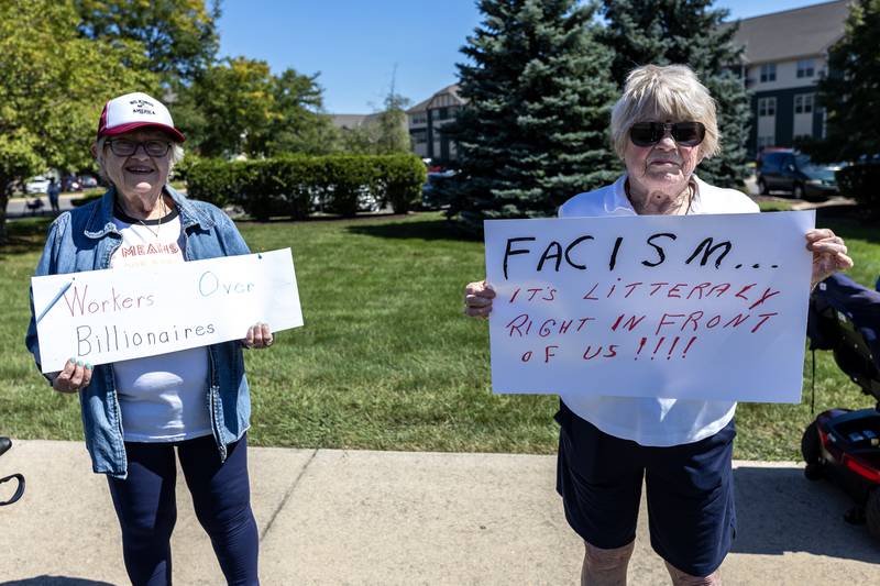 Barbara McIntosh and Janet May hold-up signs during the ‘Workers Over Billionaires’ Labor Day Protest on the 1100 block of N. River Rd. in Shorewood, IL, on Sept. 1, 2025.